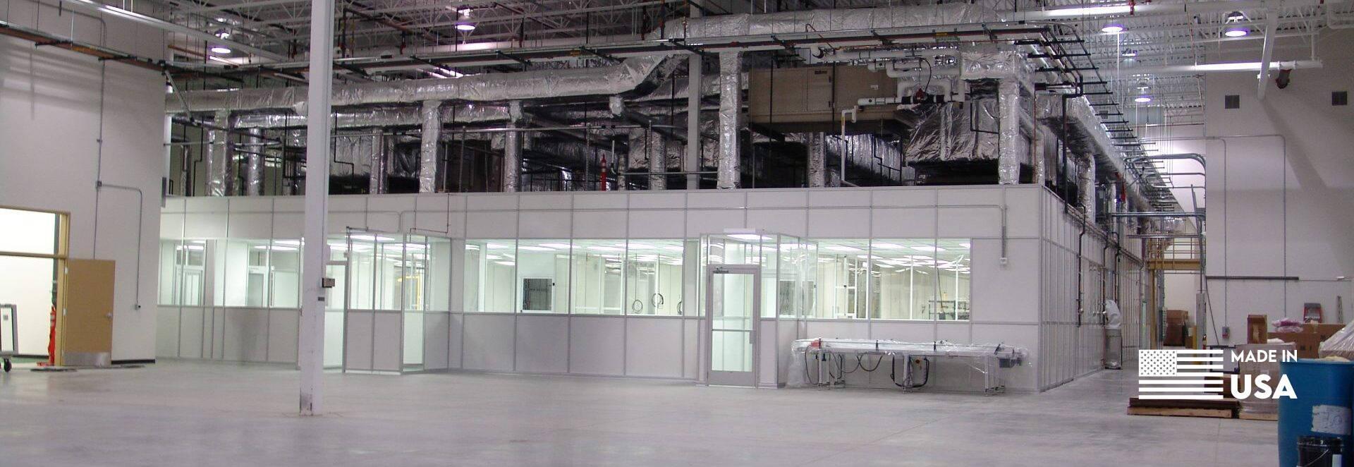 Large hardwall cleanroom by Gerbig Cleanrooms with visible piping and ducts.